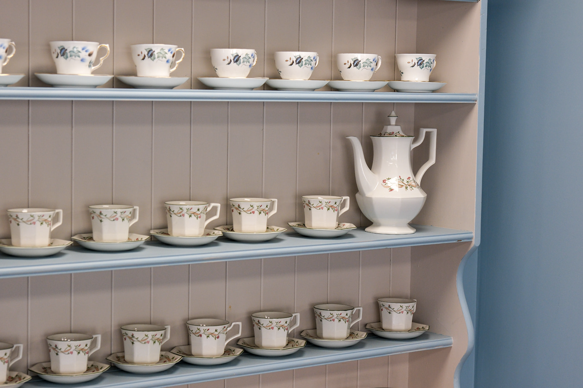 Dresser with vintage teacups and teapot